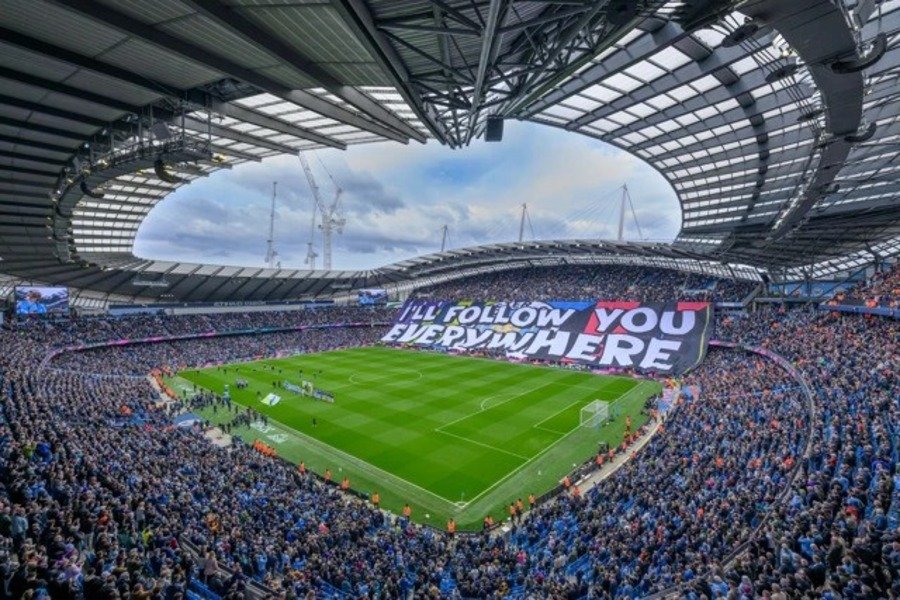Manchester City fans displaying large banner at the Etihad